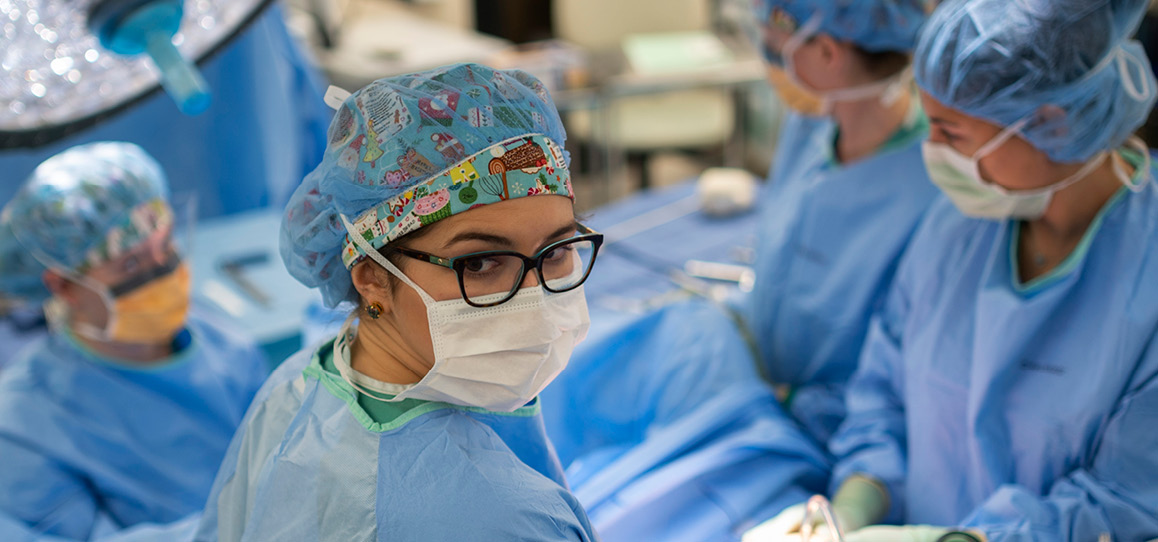 Masked obstetrics and gynecology surgeons in the operating room.