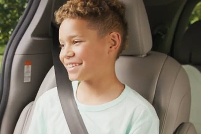 A child in a seat belt.