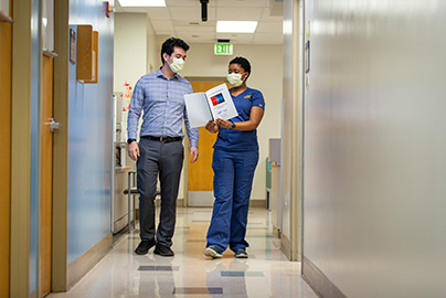 Nurse and patient walking to exam room