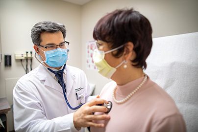 Doctor listening to patient heart beat