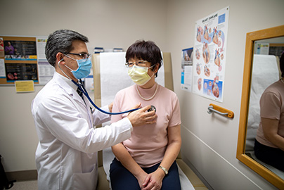 Doctor examining patient's breathing