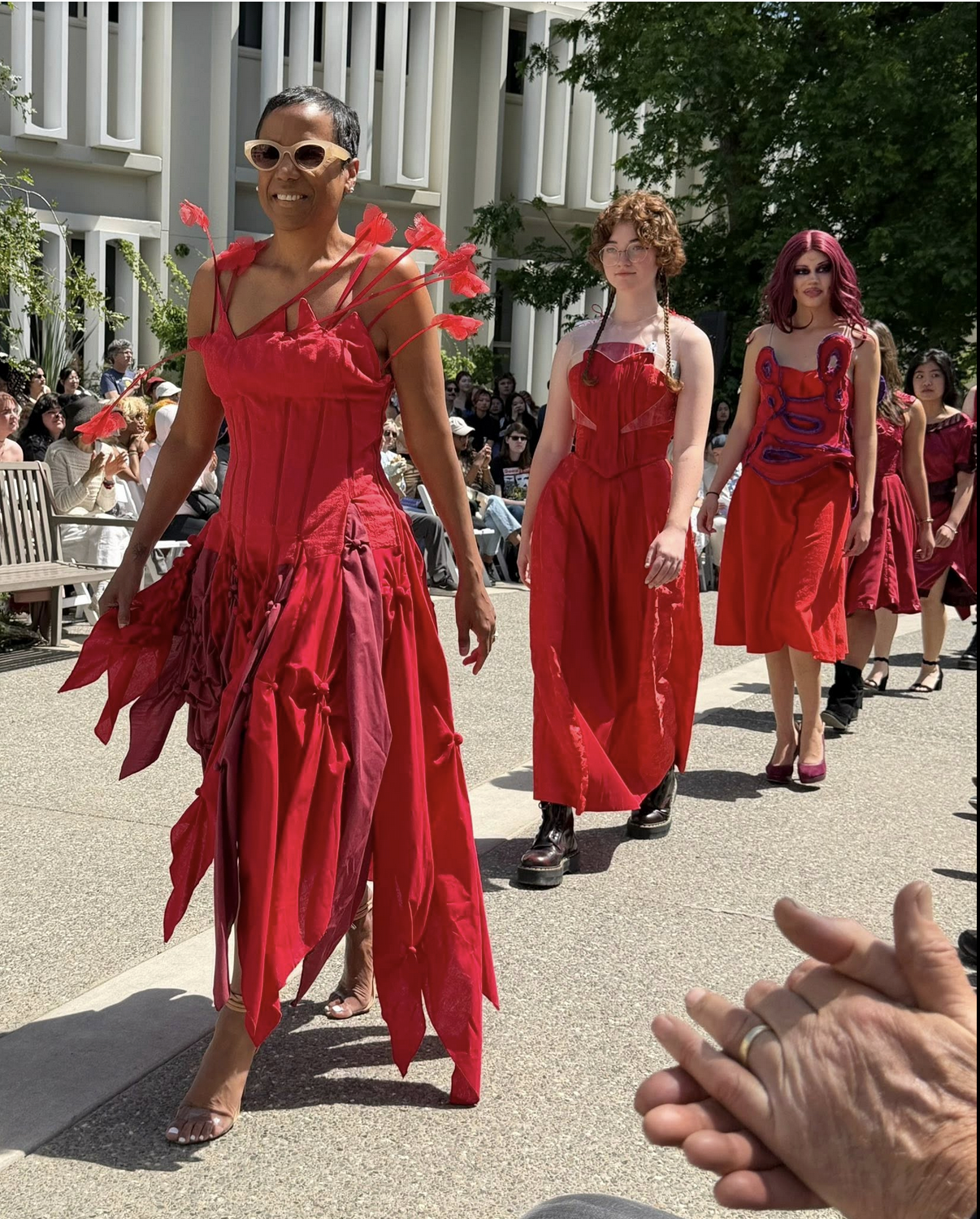 Mrs May modeling a red dress designed by UC Davis Fashion Design students modeled during the Picnic Day fashion show.