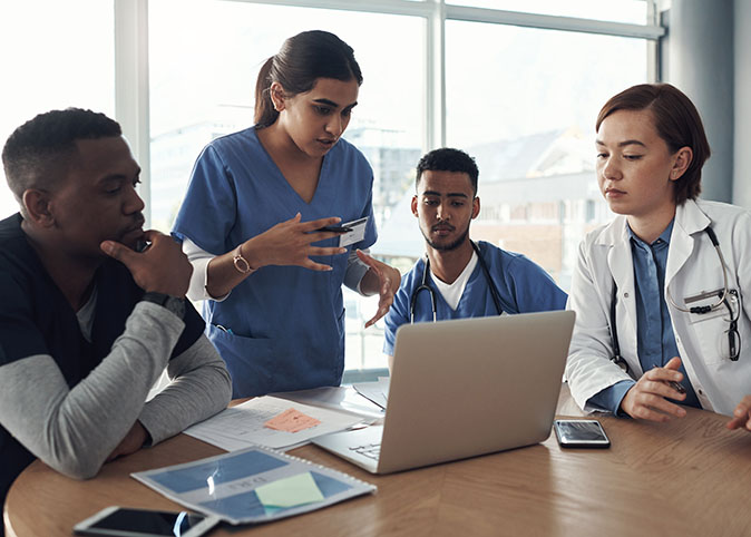 Doctor, nurse and teamwork in meeting with computer.