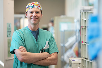 Anesthesiologist standing in hospital hallway.
