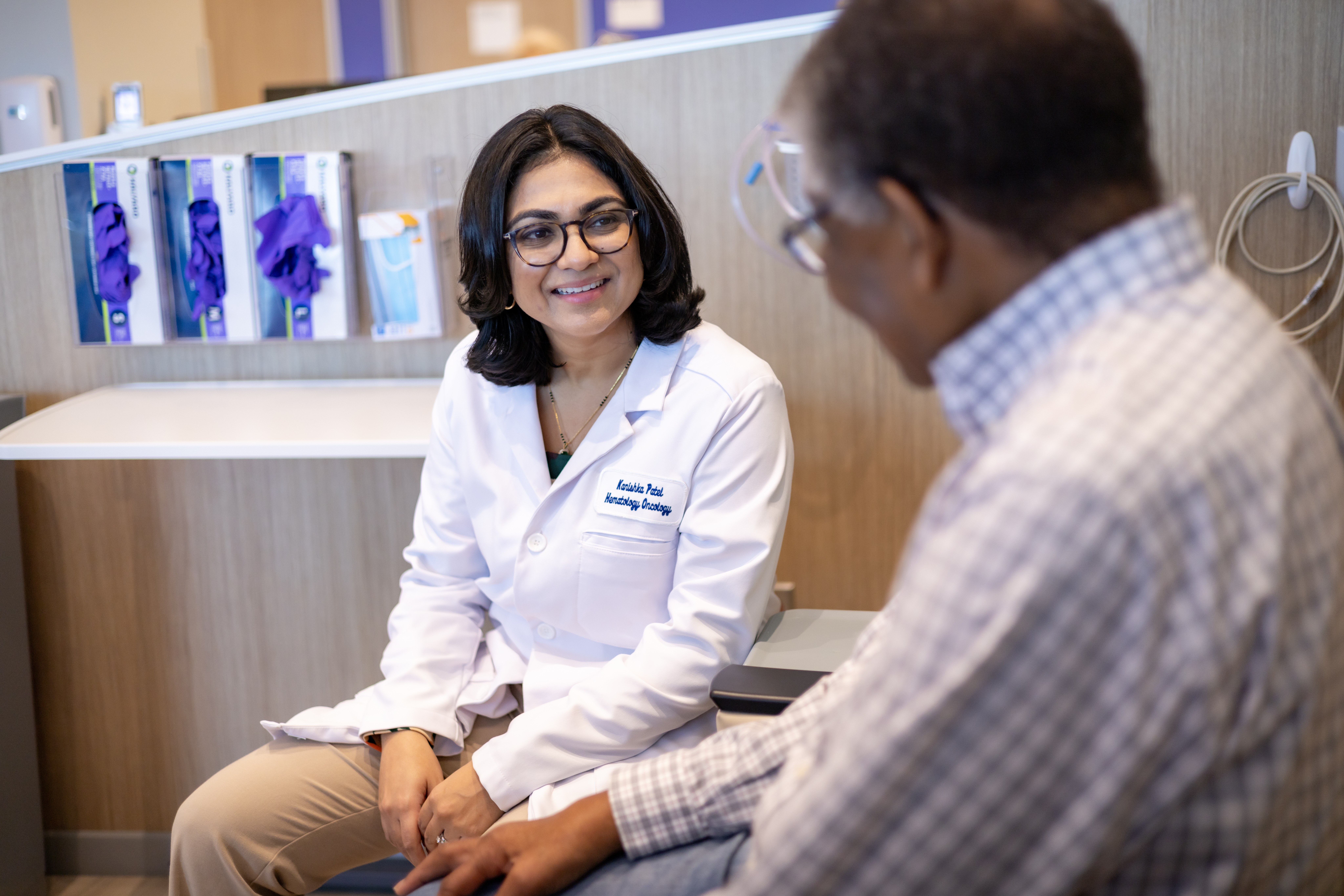 Kanishka Patel, M.D. talking with patient