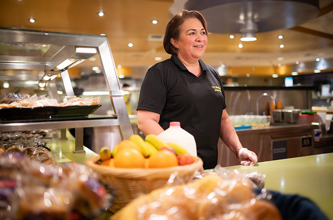 An employee behind the counter at the hospital cafeteria