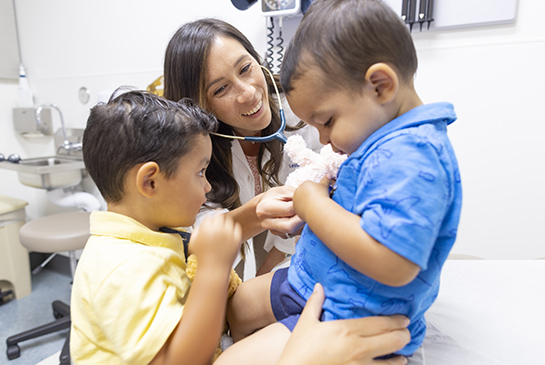 A physician listens to a patient's heart