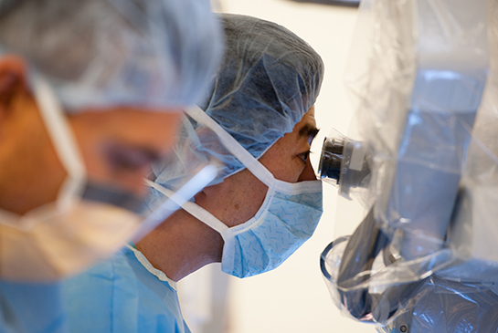 A physician looks through a device lense