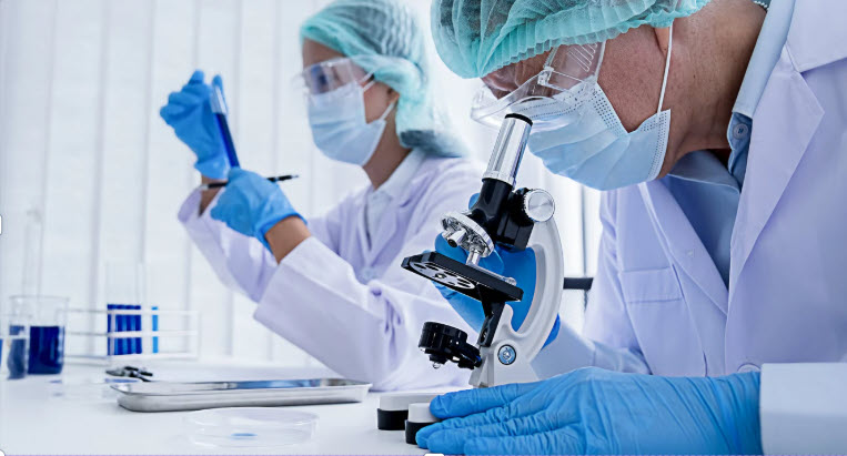 two laboratory personnel in full protective gear
