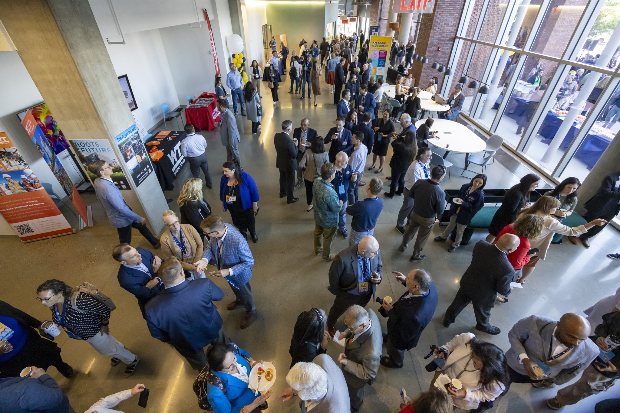 A crowd shot from overhead in the lobby of an expansive business center.