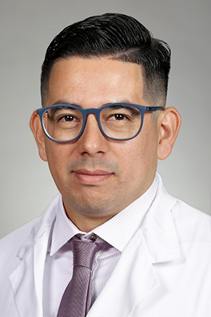 Portrait of medical student Michael Guzman Hernandez in white coat