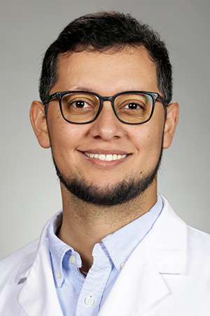 Portrait of medical student Ruben Ramirez Martinez in white coat and smiling