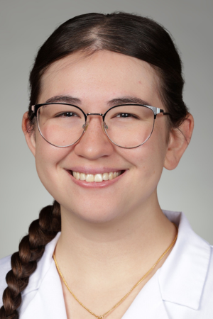 Portrait of medical student Lin Nash in white coat and smiling.