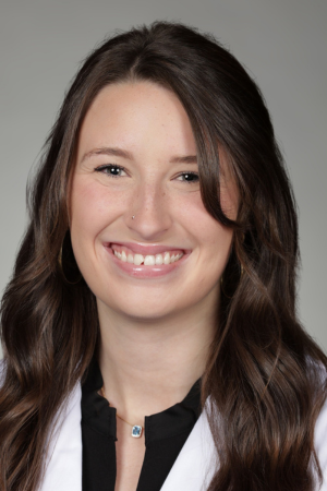 Portrait of medical student Abigail Smith in white coat and smiling.