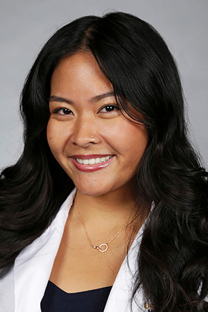 Portrait of medical student Annabella Narvarte in white coat and smiling