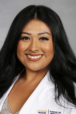 Portrait of medical student Deanna Orozco in white coat and smiling