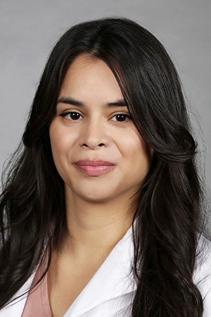 Portrait of medical student Leslie Olivares Valencia in white coat and smiling