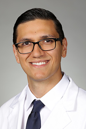 Portrait of medical student Francisco De La Fuente in white coat and smiling