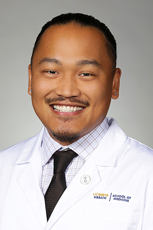 Portrait of medical student Shawn Padero in white coat and smiling
