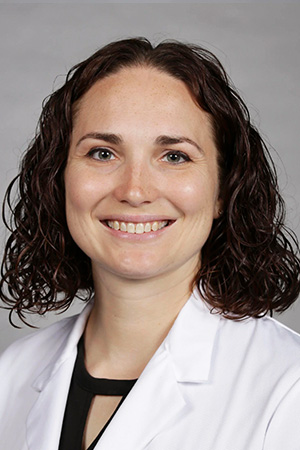 Portrait of medical student Allison Mears in white coat and smiling