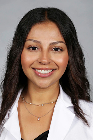 Portrait of medical student Crystal Alcala in white coat and smiling