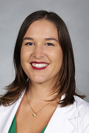 Portrait of medical student Marissa Arzate in white coat and smiling