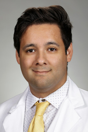 Portrait of medical student Miguel Garcia Cecena in white coat and smiling