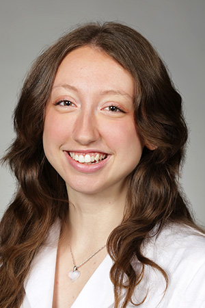 Portrait of medical student Allisun Wiltshire in white coat and smiling