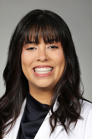 Portrait of medical student Gabriela Garcia in white coat and smiling
