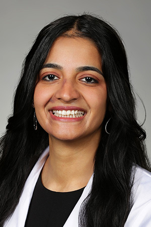 Portrait of medical student Kamalpreet Kaur in white coat and smiling