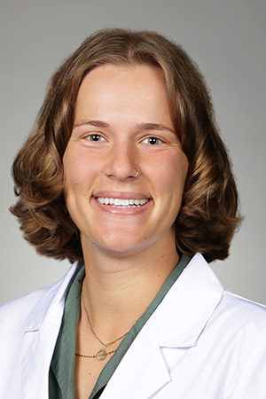 Portrait of medical student Madison Dodds in white coat and smiling