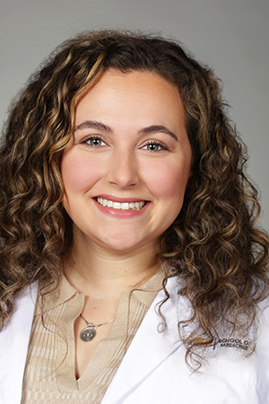 Portrait of medical student Olivia Silvera in white coat and smiling