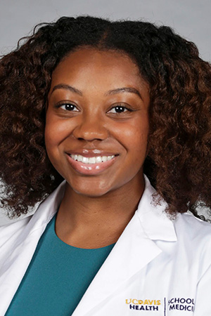 Portrait of medical student Alysha Jackson in white coat and smiling