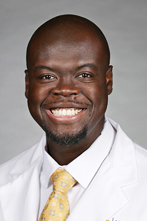 Portrait of medical student James Aboagye in white coat and smiling