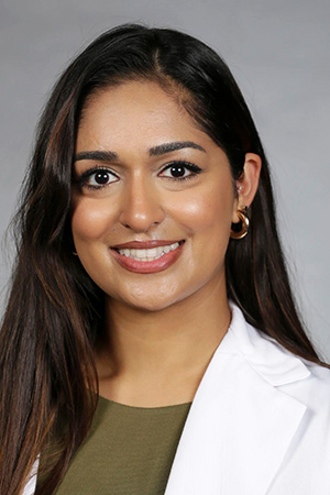 Portrait of medical student Neetu Singh in white coat and smiling