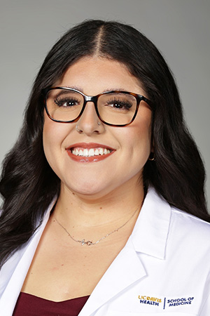 Portrait of medical student Alexandra Perez in white coat and smiling