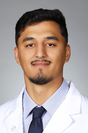 Portrait of medical student Kasim Hakimi in white coat and smiling