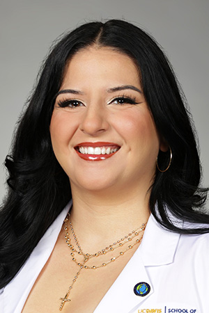 Portrait of medical student Laura Sainz Merin in white coat and smiling