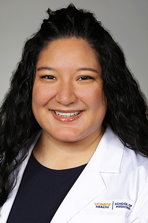 Portrait of medical student Lia Lopez in white coat and smiling