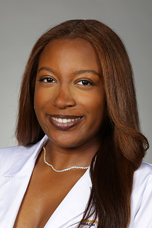 Portrait of medical student Taylonee Jackson in white coat and smiling