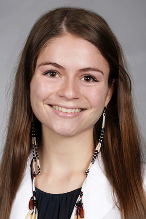 Portrait of medical student Temerity Bauer in white coat and smiling