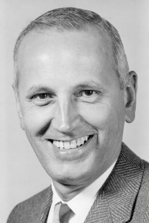Black-and-white studio portrait of Robert Bolt wearing a suit and tie, photographed against a plain background.