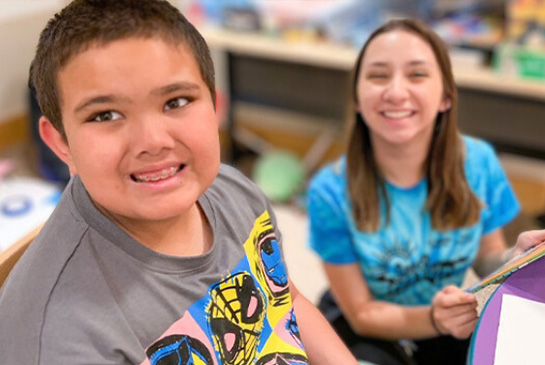 Child with Child Life Specialist both are smiling