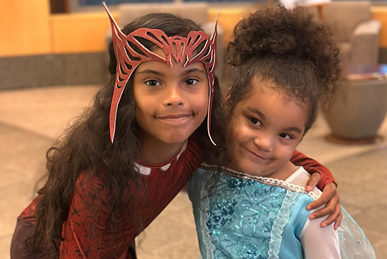 two children in costume having fun at the MIND Institute