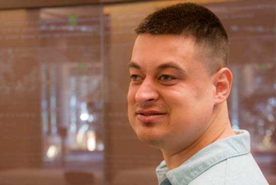 A research participant looking to the side, smiling