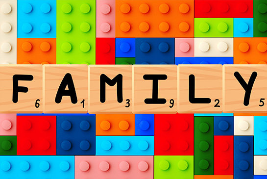 picture of scrabble tiles that say family surrounded by legos