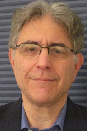 Eric London smiling in a professional headshot 