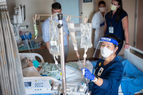 nurse with patient and others in background