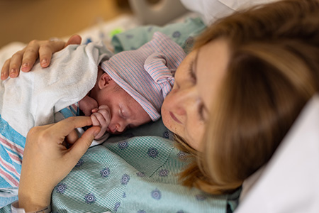 Emily and her newborn in the hospital