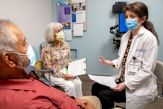 Two seniors in a clinic room with UC Davis doctor